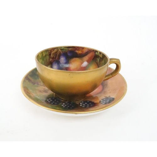 214 - A ROYAL WORCESTER FRUIT DECORATED DEMITASSE CUP AND SAUCERthe cup painted with pears and grapes, sig... 