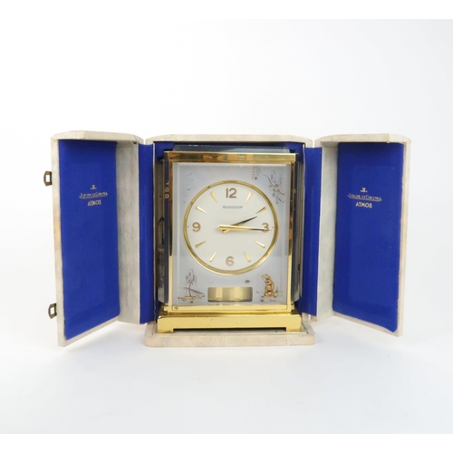 218 - A JAEGER LE COULTRE MARINA MODEL ATMOS CLOCKthe white dial within a flexi-glass and brass bound case... 