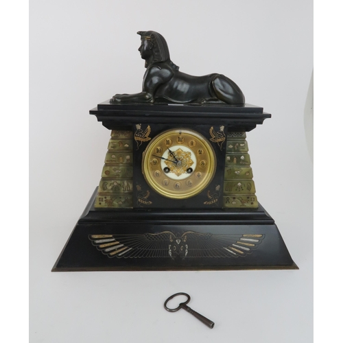 226 - A LATE 19TH CENTURY BLACK MARBLE AND GREEN ONYX EGYPTIAN REVIVAL CLOCK GARNITUREthe clock mounted wi... 