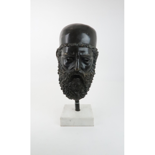 232 - A BRONZE MASK OF ZEUSresting on pole in a marble base, 54cm high... 