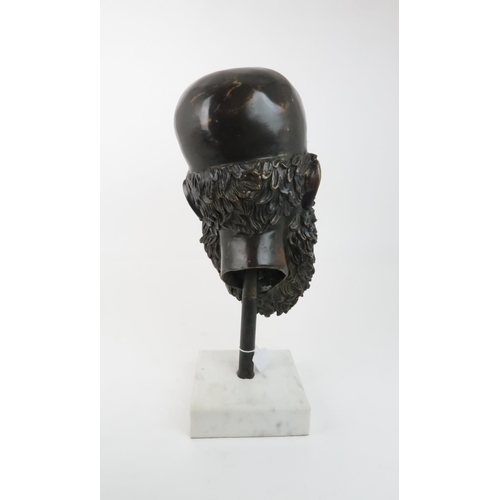 232 - A BRONZE MASK OF ZEUSresting on pole in a marble base, 54cm high... 