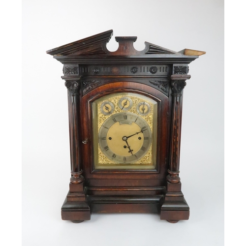 236 - A VICTORIAN CARVED OAK CASED CHIMING BRACKET CLOCKthe arched brass dial with slow/fast, chime/silent... 