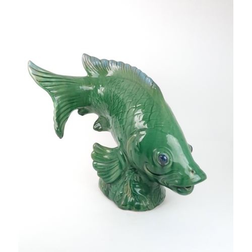 240 - A LARGE GREEN GLAZED POTTERY MODEL OF A FISH50cm high