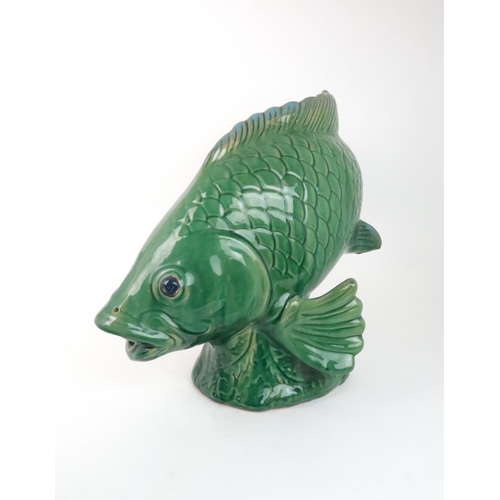 240 - A LARGE GREEN GLAZED POTTERY MODEL OF A FISH50cm high