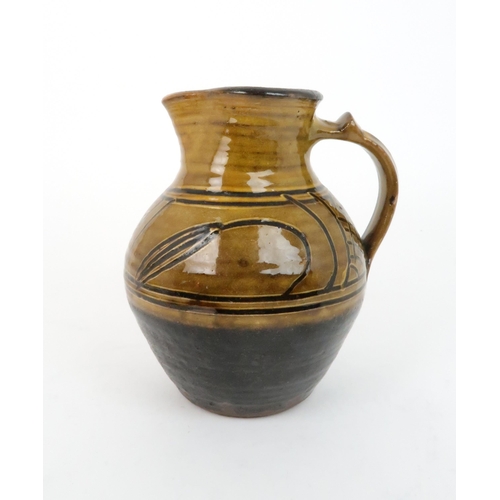 243 - MICHAEL CARDEW (BRITISH 1901-1983) FOR WINCHCOMBE POTTERY slipware jug of baluster form with scroll ... 