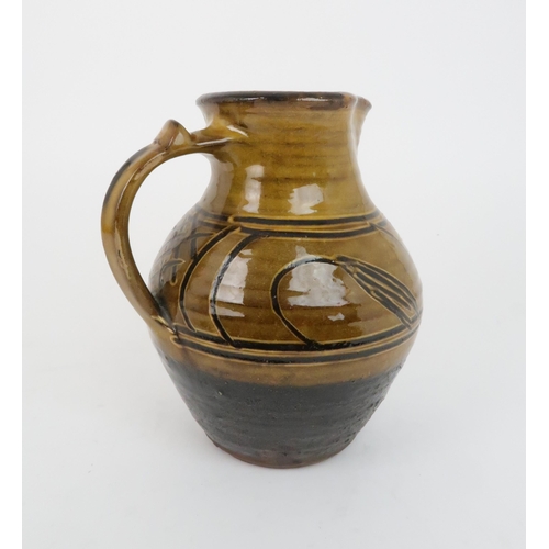 243 - MICHAEL CARDEW (BRITISH 1901-1983) FOR WINCHCOMBE POTTERY slipware jug of baluster form with scroll ... 