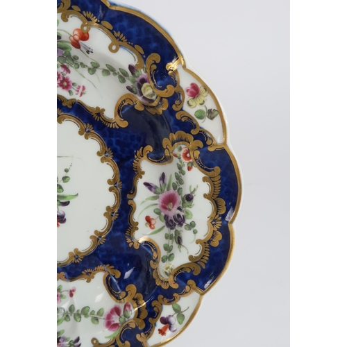 244 - AN EARLY WORCESTER BLUE GROUND PLATEpainted with hand painted bouquets of flowers, 19cm diameter... 