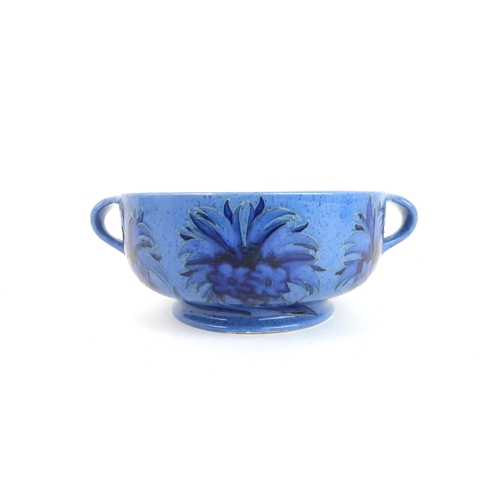 246 - WILLIAM MOORCROFT (1872-1945) TWO HANDLED BOWLdecorated in the Cornflower design on powder blue grou... 