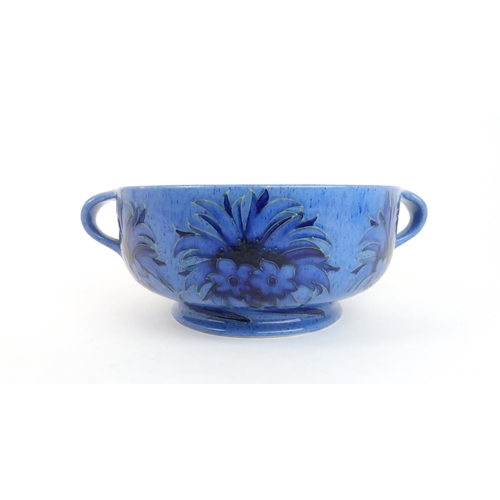 246 - WILLIAM MOORCROFT (1872-1945) TWO HANDLED BOWLdecorated in the Cornflower design on powder blue grou... 