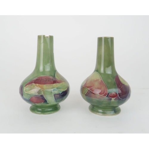 247 - WILLIAM MOORCROFT (1872-1945) A PAIR OF CLAREMONT PATTERN VASESof squat baluster bottle form, decora... 