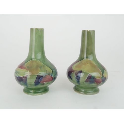 247 - WILLIAM MOORCROFT (1872-1945) A PAIR OF CLAREMONT PATTERN VASESof squat baluster bottle form, decora... 