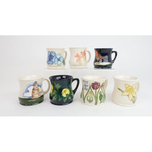 300 - A COLLECTION OF SEVEN MOORCROFT MUGSincluding Robin, Tudor Rose, Buttercup designed Sally Tuffin, Bo... 