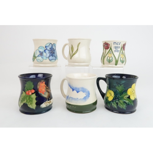 300 - A COLLECTION OF SEVEN MOORCROFT MUGSincluding Robin, Tudor Rose, Buttercup designed Sally Tuffin, Bo... 