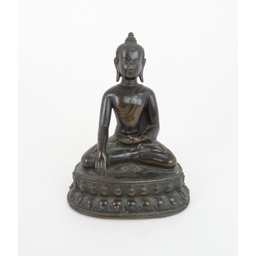 404 - A CHINESE BRONZE MODEL OF BUDDHAof traditional type and raised on a lotus throne, 13cm high... 