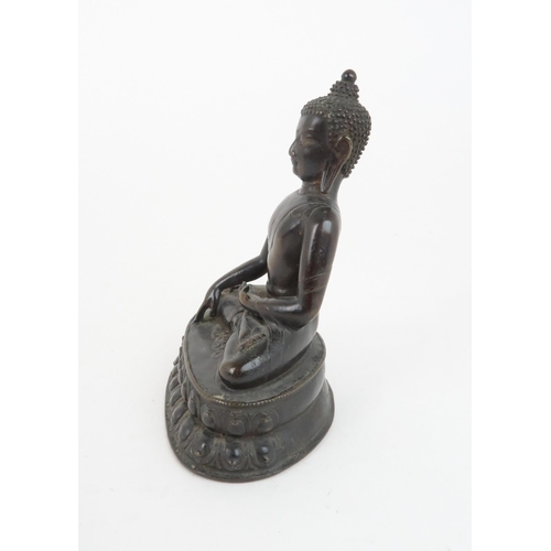 404 - A CHINESE BRONZE MODEL OF BUDDHAof traditional type and raised on a lotus throne, 13cm high... 