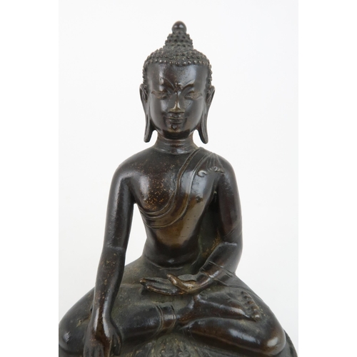 404 - A CHINESE BRONZE MODEL OF BUDDHAof traditional type and raised on a lotus throne, 13cm high... 