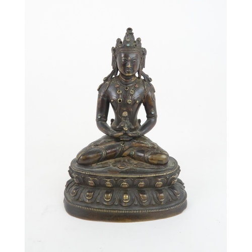 405 - A CHINESE BRONZE MODEL OF BUDDHAseated and wearing a high jewelled crown and holding a vessel, seate... 