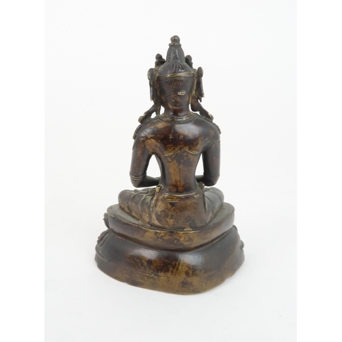 405 - A CHINESE BRONZE MODEL OF BUDDHAseated and wearing a high jewelled crown and holding a vessel, seate... 