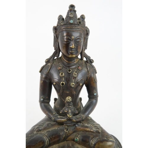 405 - A CHINESE BRONZE MODEL OF BUDDHAseated and wearing a high jewelled crown and holding a vessel, seate... 