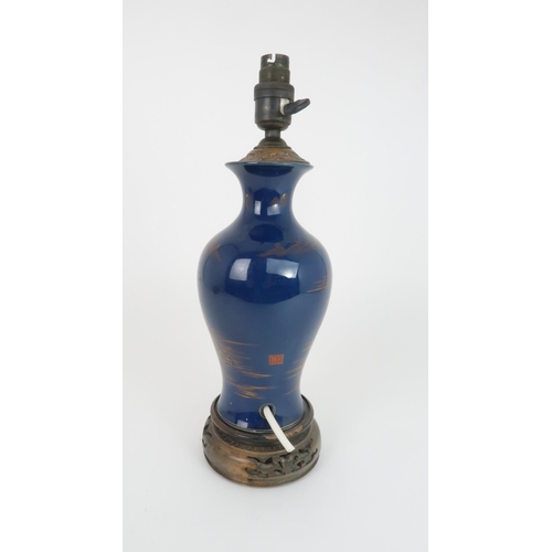 409 - A CHINESE POWDER BLUE BALUSTER VASEpainted in gilt with a river landscape, converted to a lamp, wood... 