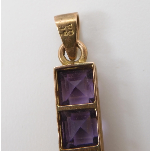 754 - A GOLD & AMETHYST CROSSthe square cut amethysts are set into a galleried mount, stamped 9c to th... 