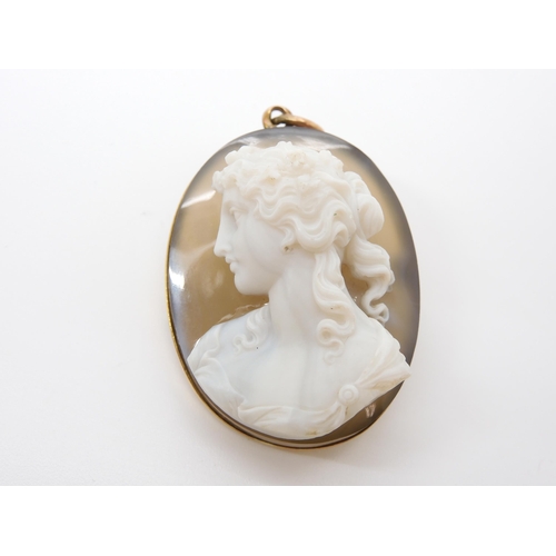 755 - A CRAFTSMAN CARVED AGATE CAMEO OF A MAIDEN mounted as a pendant brooch in yellow metal, dimensions 4... 