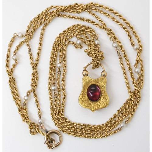 756 - A YELLOW METAL & PEARL GUARD CHAIN WITH GARNET CLASPthe bright yellow metal rope chain, is inter... 