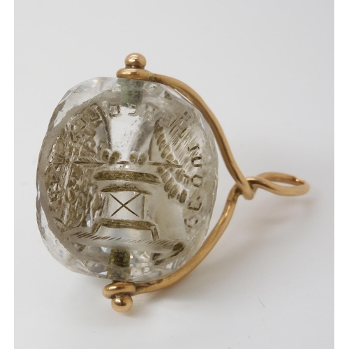 767 - AN INTAGLIO CARVED SWIVEL SEALthe three sided rock crystal carved with a motto in French, 'Ce Qui pe... 