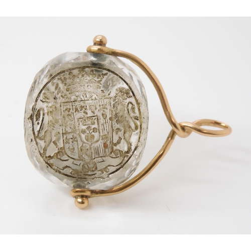 767 - AN INTAGLIO CARVED SWIVEL SEALthe three sided rock crystal carved with a motto in French, 'Ce Qui pe... 