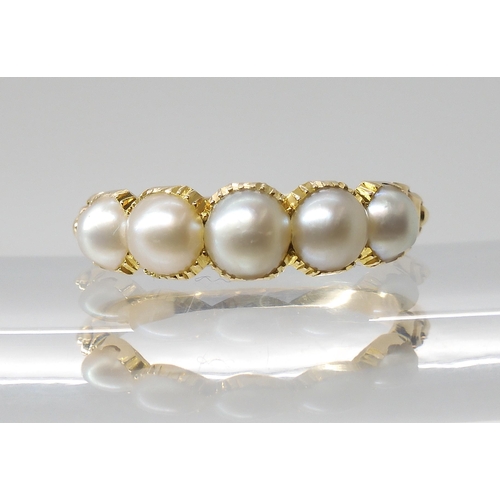 768 - A BRIGHT YELLOW METAL PEARL RINGthe five half pearls are in cut back settings with reeded shoulders,... 