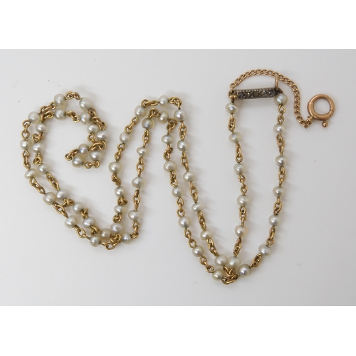 770 - A STRING OF NATURAL PEARLSindividually strung on yellow metal wire with rose cut diamond clasp. Each... 