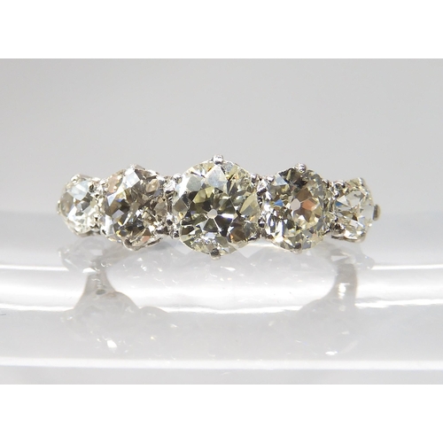 774 - A FIVE STONE DIAMOND RINGmounted in white metal with a finely made gallery, the five diamonds combin... 