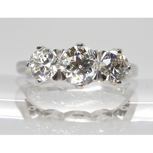 776 - A PLATINUM THREE STONE DIAMOND RINGset with estimated approx 1.90cts of old cut diamonds combined. F... 