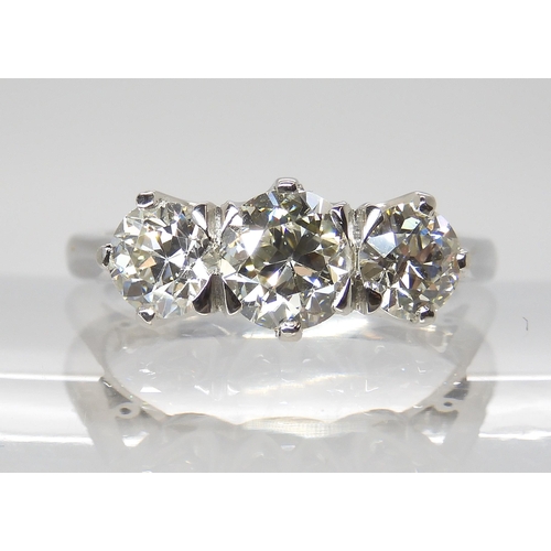 776 - A PLATINUM THREE STONE DIAMOND RINGset with estimated approx 1.90cts of old cut diamonds combined. F... 