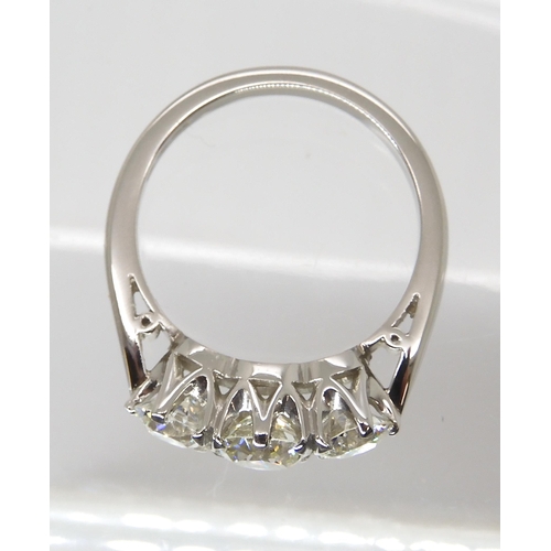 776 - A PLATINUM THREE STONE DIAMOND RINGset with estimated approx 1.90cts of old cut diamonds combined. F... 