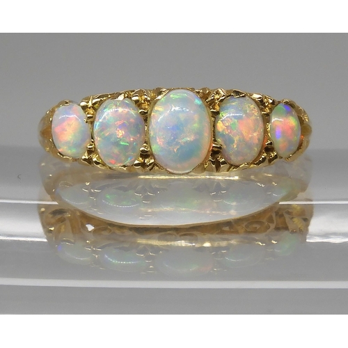 790 - AN 18CT GOLD FIVE STONE OPAL RINGthe opals are very lively with the full spectrum of colours, well m... 