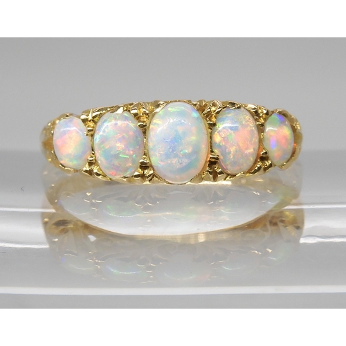 790 - AN 18CT GOLD FIVE STONE OPAL RINGthe opals are very lively with the full spectrum of colours, well m... 