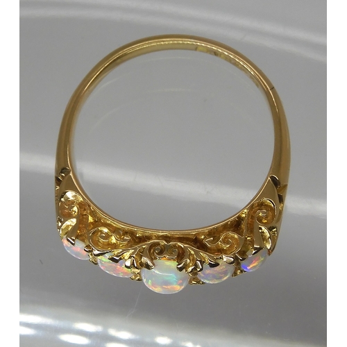 790 - AN 18CT GOLD FIVE STONE OPAL RINGthe opals are very lively with the full spectrum of colours, well m... 