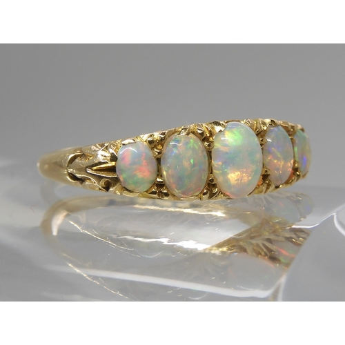 790 - AN 18CT GOLD FIVE STONE OPAL RINGthe opals are very lively with the full spectrum of colours, well m... 