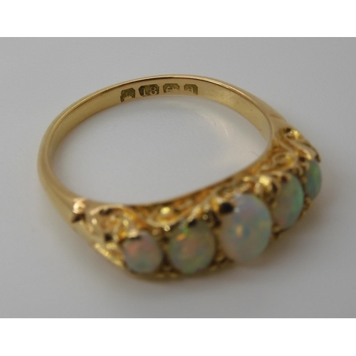 790 - AN 18CT GOLD FIVE STONE OPAL RINGthe opals are very lively with the full spectrum of colours, well m... 