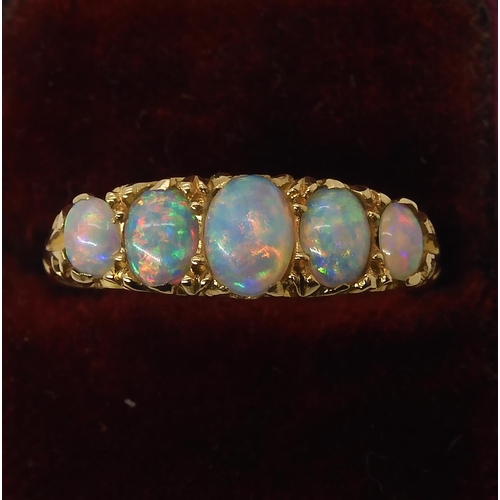 790 - AN 18CT GOLD FIVE STONE OPAL RINGthe opals are very lively with the full spectrum of colours, well m... 