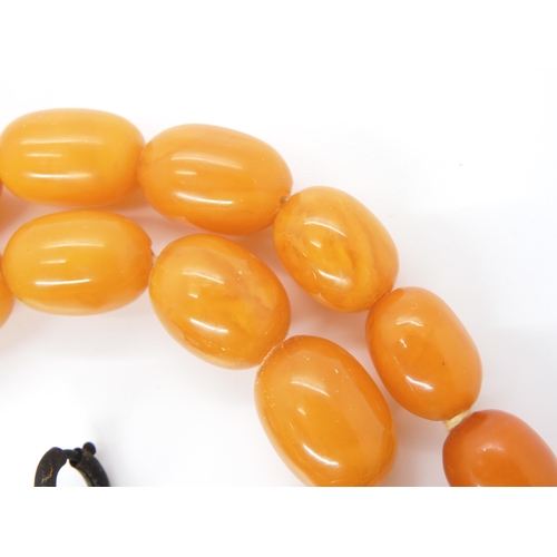 791 - A STRING OF AMBER BEADSlargest bead approx 23.2mm x 17.3mm, to smallest 13.5mm x 9.7mm, length 49cm.... 