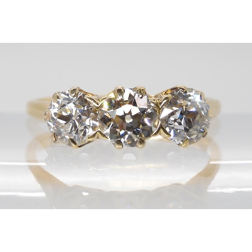 797 - A THREE STONE DIAMOND RINGset with estimated approx, 1.78cts of old cut diamonds in classic crown mo... 