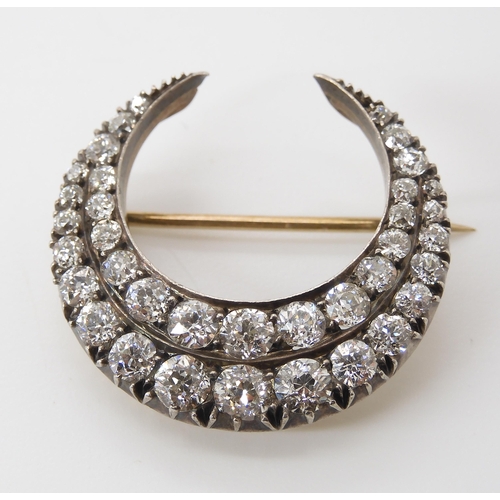 814 - A DIAMOND CRESCENT MOON BROOCHset with estimated approx 2.83cts of old cut diamonds set in yellow an... 