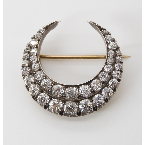 814 - A DIAMOND CRESCENT MOON BROOCHset with estimated approx 2.83cts of old cut diamonds set in yellow an... 