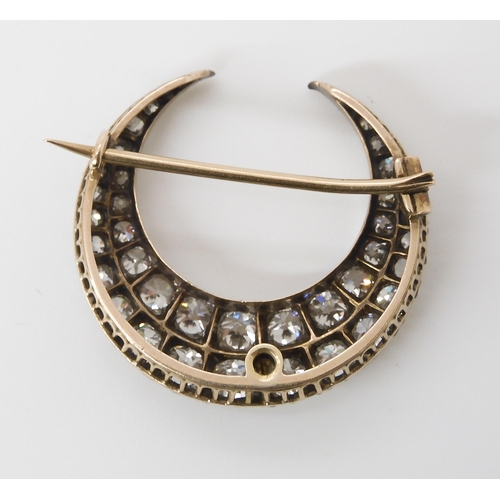 814 - A DIAMOND CRESCENT MOON BROOCHset with estimated approx 2.83cts of old cut diamonds set in yellow an... 