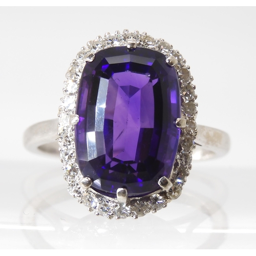 815 - AN 18CT AMETHYST AND DIAMOND CLUSTER RINGmade in 18ct white gold the fancy cushion cut amethyst is a... 