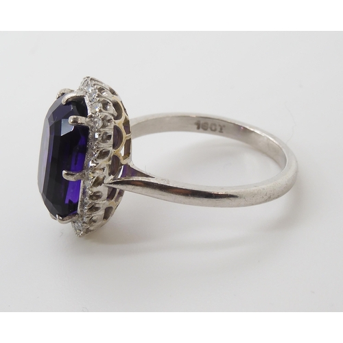 815 - AN 18CT AMETHYST AND DIAMOND CLUSTER RINGmade in 18ct white gold the fancy cushion cut amethyst is a... 