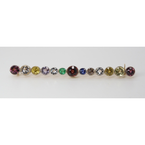 816 - A LARGE RAINBOW GEM SET BROOCH to include garnets, sapphire and emerald, set in yellow metal ga... 