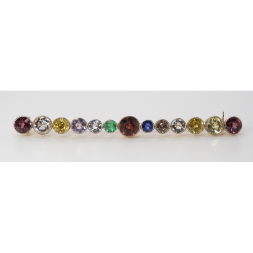 816 - A LARGE RAINBOW GEM SET BROOCH to include garnets, sapphire and emerald, set in yellow metal ga... 